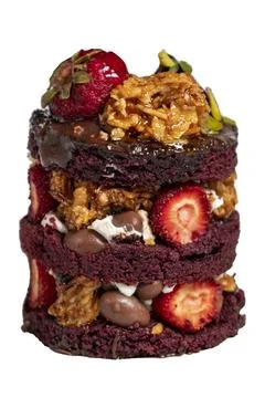 Layer cake. Strawberry, pistachio, croquant and cream cake isolated on white  Stock Photos