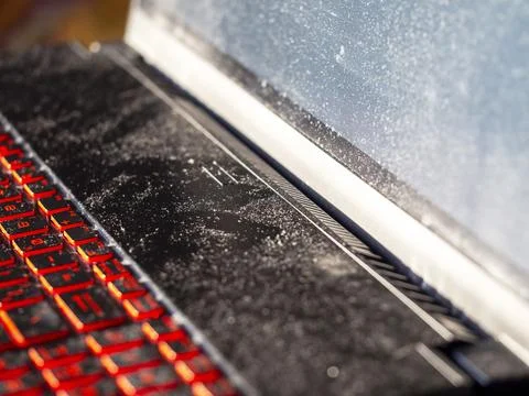 Layer of dust on the laptop . The concept of dirt and allergies . Stock Photos