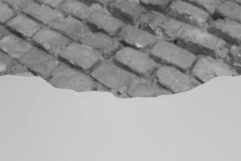 A layer of finished stucco gradually covers the defocused brick wall Stock Photos