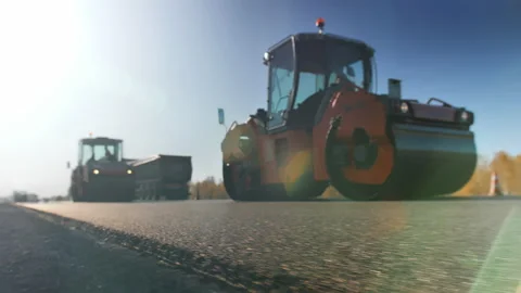 A layer of freshly laid asphalt in the rays of the setting sun. Road surface Stock Footage 138158088