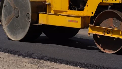 A layer of freshly laid asphalt in the rays of the setting sun. Road surface Stock Footage 154578218