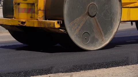 A layer of freshly laid asphalt in the rays of the setting sun. Road surface Stock Footage 154790934