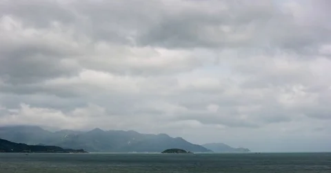 Layer of Gray Clouds Drifting over Tropical Bay in Timelapse Stockbeeldmateriaal 76152824