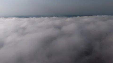 Layer of morning clouds seen from a plane at sunrise, with golden sunlight .. Video stock 319985869