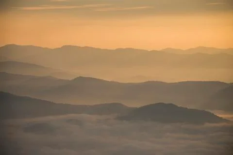 Layer of mountains and mist during sunset Stock Photos