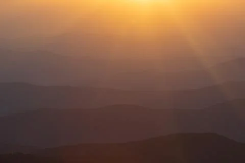 Layer of mountains and mist during sunset Stock Photos