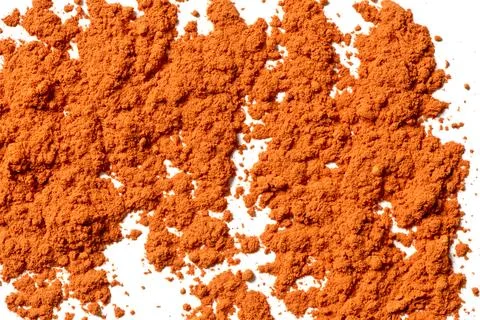A layer of orange powder on a white background Stock Photos