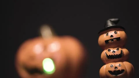 Layer of Pumpkins Face with Sparkling Pumpkin Face in Black Background Stock Footage 153585024