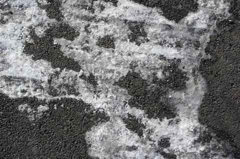 Layer of white snow on surface of grey asphalt road Stock Photos
