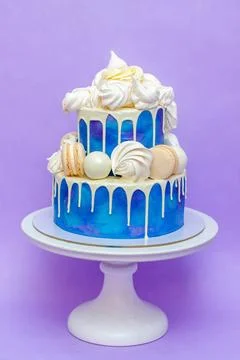 Layered blue cake on cake stand on a purple background. A picture for a menu  Stock Photos