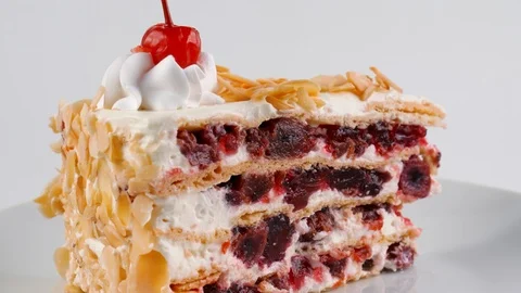 Layered cake with cherries, cream and sliced almonds Stock Footage 87176562
