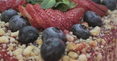 Layered cake decorated with fruit jam, strawberries and blueberries Stock Footage 301871022