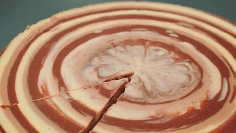 Layered chocolate and cream cake being sliced indoors on table Stock Footage 342879911