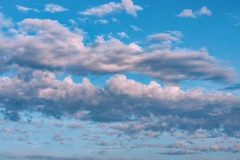 Layered Clouds Across Blue Evening Sky Background Stock Photos