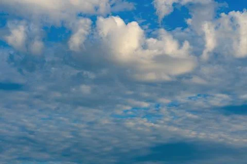 Layered Clouds Across Blue Evening Sky Background Stock Photos