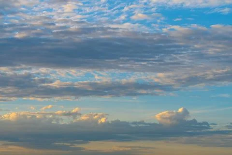 Layered Clouds Across Blue Evening Sky Background Stock Photos