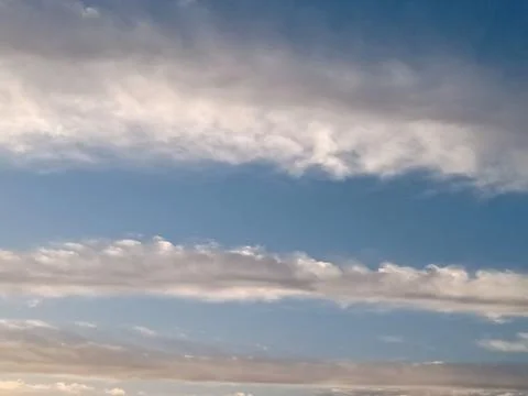 Layered Clouds in a Clear Blue Sky Stock Photos