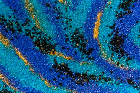 Layered colorful sand pattern. Marble style background. Blue and gold powder Stock Photos