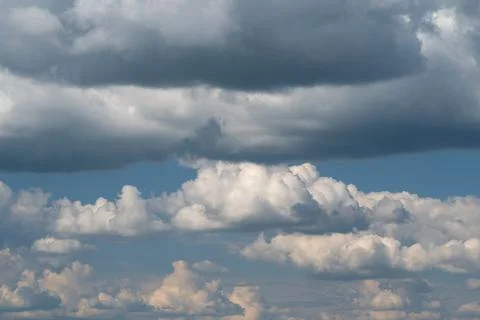 Layered cumulus clouds beneath a dramatic storm sky Stock Photos