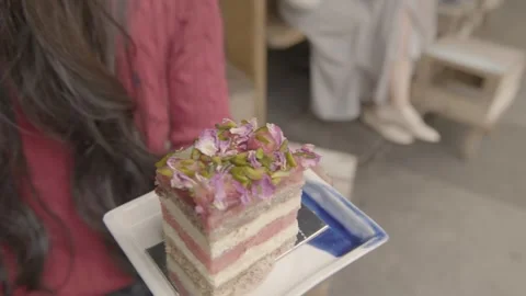 Layered Dessert with Flower and Nut Topping Held by Person at Sydney Cafe Stock Footage 345654901