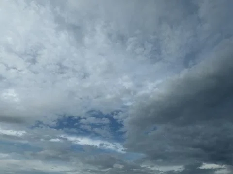 Layered Gray and White Clouds Over Blue Sky Stock Photos