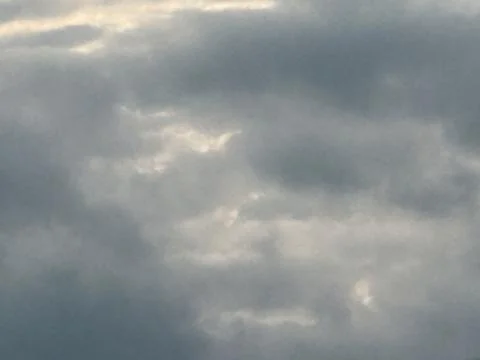 Layered Gray Clouds with Soft Sunlight Stock Photos