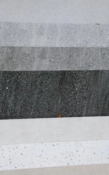 Layered gray tile samples with modern granite texture. Stock Photos
