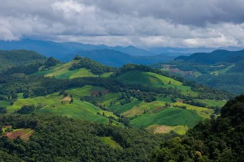 Layered Green Mountains Under Dramatic Cloudy Sky In Rural Southeast Asia V.. Photos