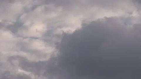 Layered grey overcast clouds moving and covering the horizon in a dramatic .. Video stock 331245639