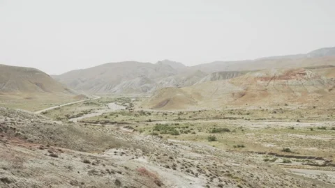 Layered hills and a broad dry valley stretch across the Candy Cane Hills in Stock Footage 345258358