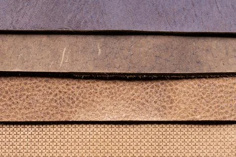 Layered Leather Sheets in Brown Tan and Purple Tones Showing Grain Texture .. Stock Photos