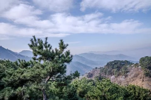 Layered mountain ranges under clouds near Great Wall Stock Photos