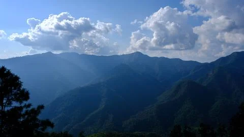 Layered Mountain Ridges Under Clear Blue Sky Tropical Highlands Wide Shot Foto stock