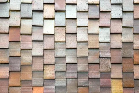 Layered multicolor tiled wall structure with overlapping rectangular elements Stock Photos