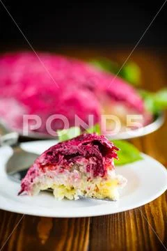 Layered pastry salad with herring and beetroot Stock Photos