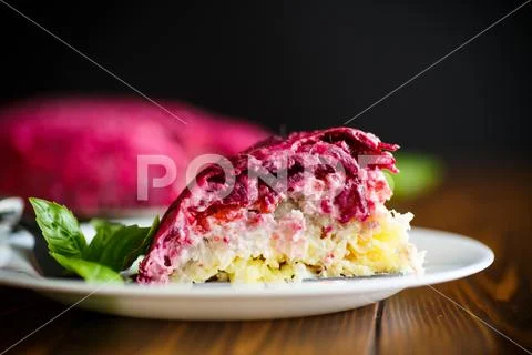 Layered pastry salad with herring and beetroot Stock Photos