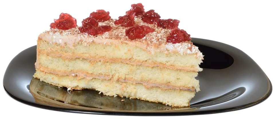 Layered piece of cake close up on a black plate Stock Photos