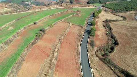 Layered Red Fields Beneath Distant Mountains in Dongchuan, China Stock Footage 344038192