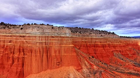 Layered red sandstone cliff face with eroded hoodoo, Teruel, Spain Stock Footage 337465567