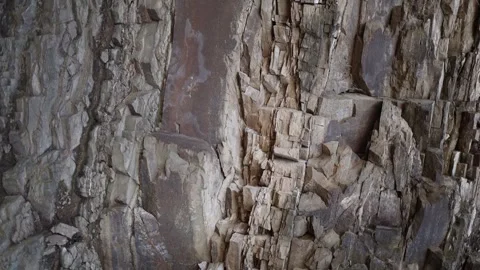 Layered rock cliff with raw stone texture Video stock 331704392
