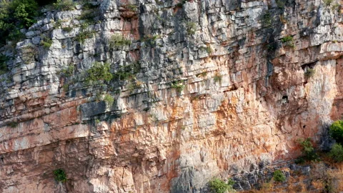 Layered rock formation on a hillside. Dipping sedimentary rock strata mountain Stock Footage 156705457