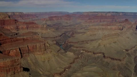 Layered rock formations fill a vast and deep canyon Stock Footage 329761185