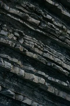 Layered rock formations with visible textures and geological features Stock Photos