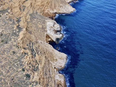 Layered rocks meet ocean rhythm, Successive coves and layered rocks create .. Stock Photos