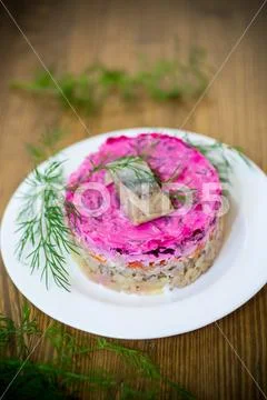 Layered salad of boiled vegetables with beets and herring Stock Photos
