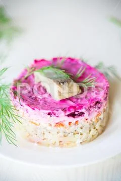 Layered salad of boiled vegetables with beets and herring Stock Photos