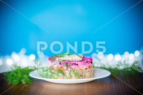 Layered salad of boiled vegetables with beets and herring Stock Photos
