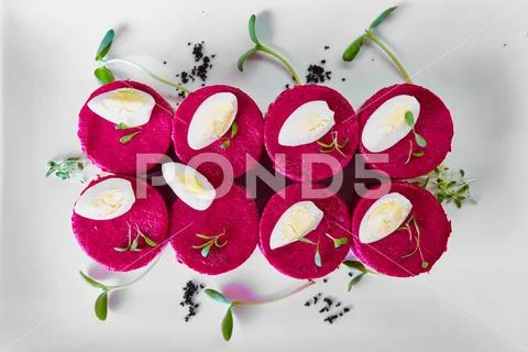 Layered salad with herring, beets, carrots, onions, potatoes and eggs close-up Stock Photos
