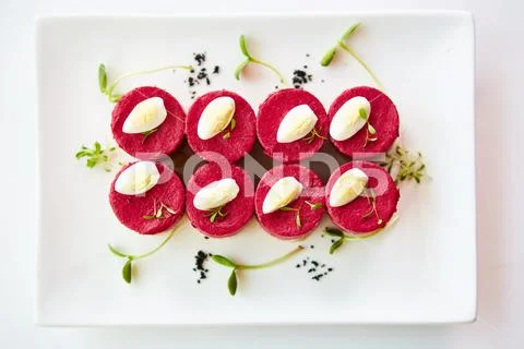 Layered salad with herring, beets, carrots, onions, potatoes and eggs close-up Stock Photos