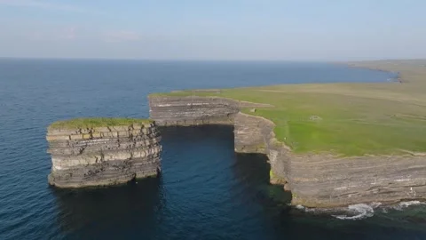 Layered Sea Stack Dun Briste Beside Flat Cliff Top Grassland, Daytime Drone Stock Footage 342055866